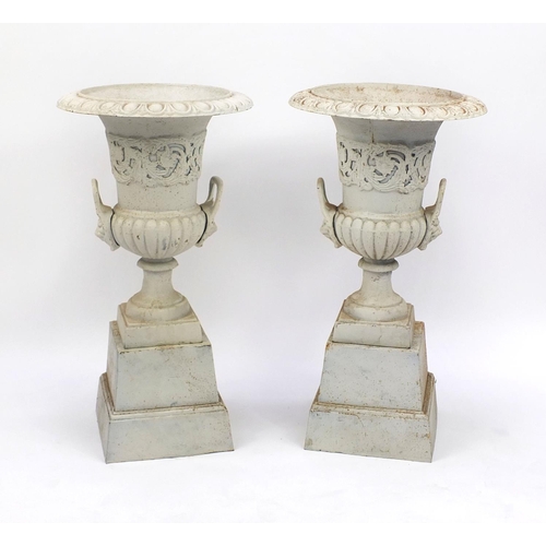 2012 - Pair of cast iron campana shaped urns on stands, with lion mask handles, 84cm high