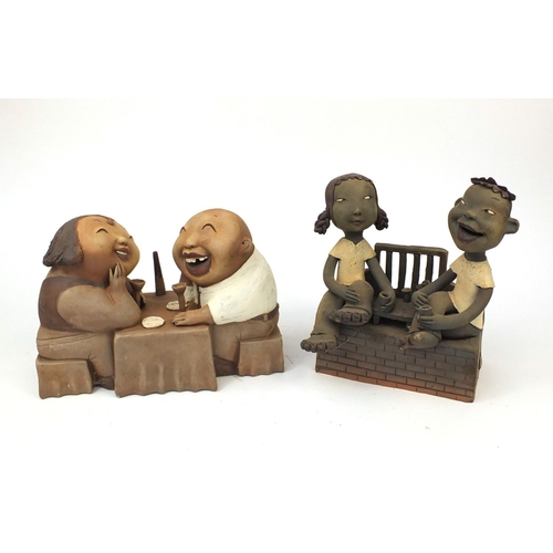 2358 - Two comical Chinese terracotta figure groups  one of two lovers sitting at a dinner table and one of... 