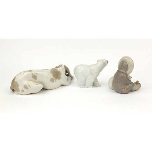 2131 - Lladro model of a dog laying down together with a Lladro polar bear and eskimo with polar bear, each... 