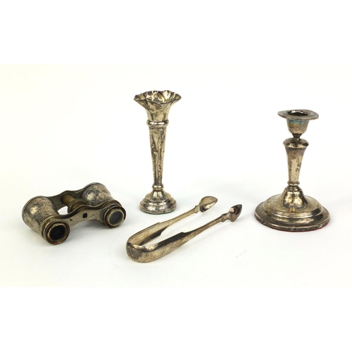 2436 - Silver items comprising a pair of Georgian sugar tongs, candle stick, bud vase and pair of silver mo... 