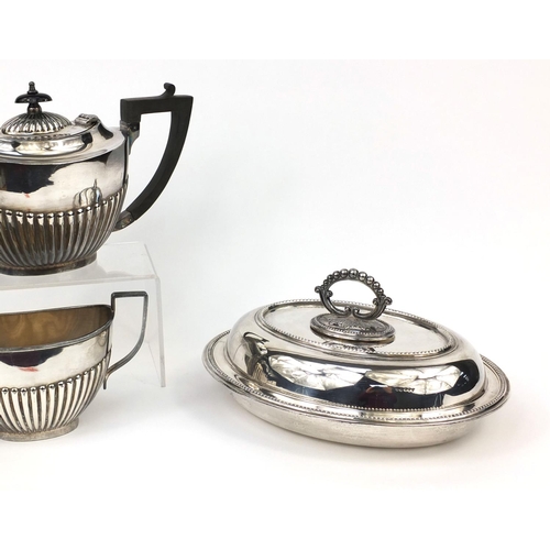 2484 - Silver plated three piece tea set with demi fluted decoration and an entrée dish with cover, the tea... 