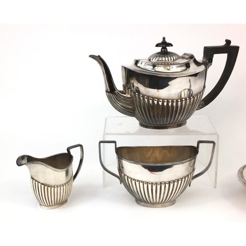 2484 - Silver plated three piece tea set with demi fluted decoration and an entrée dish with cover, the tea... 