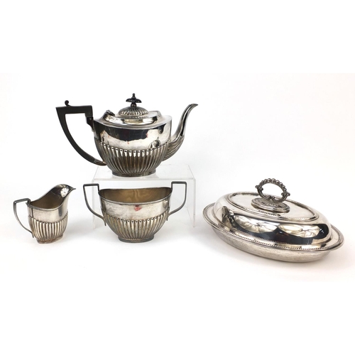 2484 - Silver plated three piece tea set with demi fluted decoration and an entrée dish with cover, the tea... 