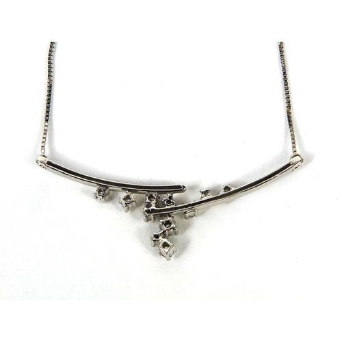 2540 - 18ct white gold diamond necklace, set with eleven diamonds, 18cm long, approximate weight 3.0g