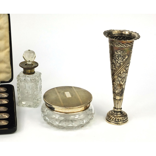 2419 - Silver items comprising a William Comyns bud vase, four glass bottles with silver lids, glass powder... 