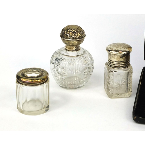 2419 - Silver items comprising a William Comyns bud vase, four glass bottles with silver lids, glass powder... 