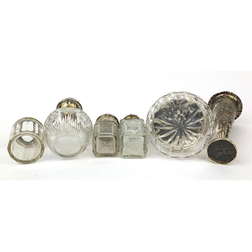 2419 - Silver items comprising a William Comyns bud vase, four glass bottles with silver lids, glass powder... 