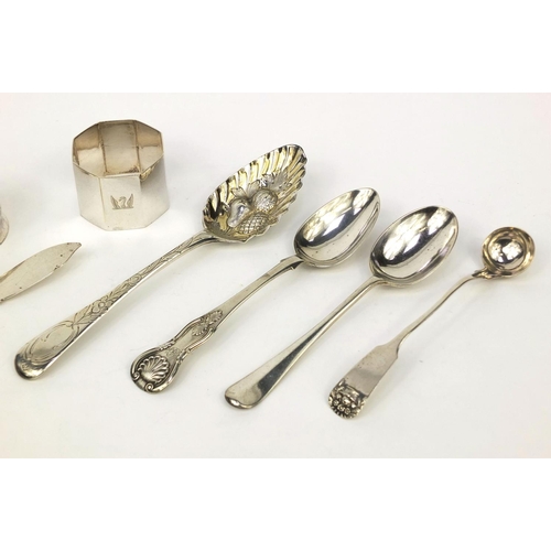 2469 - Silver items comprising three Georgian spoons, Scottish spoon, a strainer, two napkin rings and butt... 