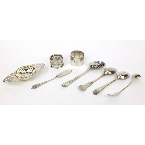 2469 - Silver items comprising three Georgian spoons, Scottish spoon, a strainer, two napkin rings and butt... 