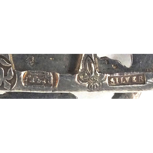 2428 - Silver belt buckle relief decorated with flowers, stamped 925, together with a silver coloured metal... 