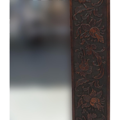 2039 - Large hard wood bevelled edged mirror carved with flowers and foliage, 166cm x 84cm