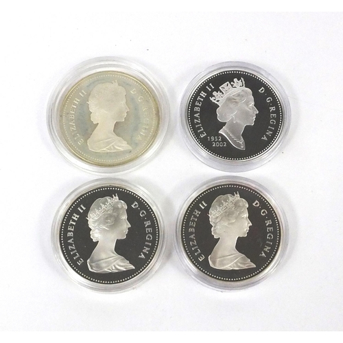 2757 - Four Canadian silver dollars including one commemorating the 150th Anniversary of Toronto, a 2002 ex... 