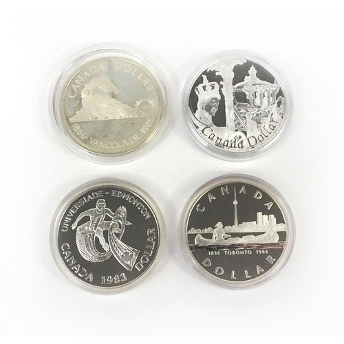 2757 - Four Canadian silver dollars including one commemorating the 150th Anniversary of Toronto, a 2002 ex... 