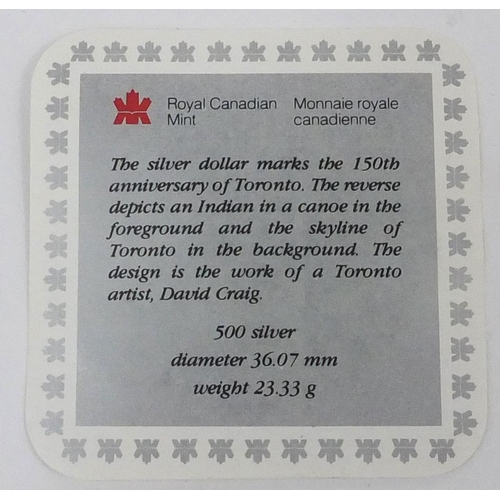 2757 - Four Canadian silver dollars including one commemorating the 150th Anniversary of Toronto, a 2002 ex... 