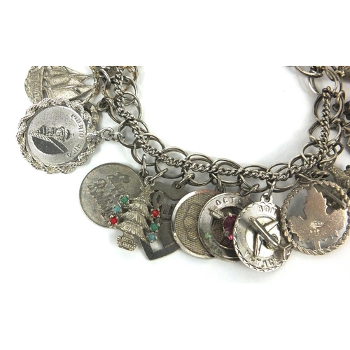 2563 - Silver charm bracelet with a selection of mostly silver charms, approximate weight 66.7g