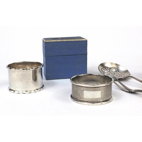 2438 - Silver items comprising two napkin rings, circular dish with pierced decoration and two spoons toget... 