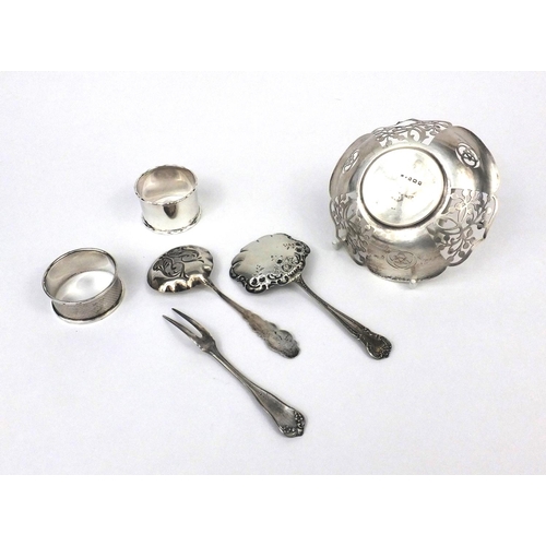 2438 - Silver items comprising two napkin rings, circular dish with pierced decoration and two spoons toget... 