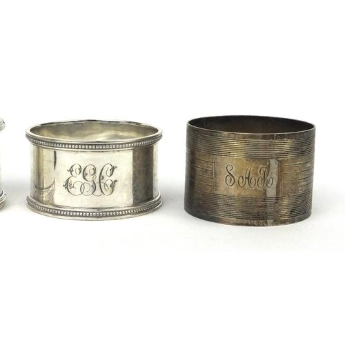 2477 - Five assorted circular silver napkin rings, one with engine turned decoration, various hallmarks, ap... 