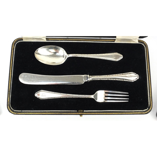 2472 - Four cased sets of silver items comprising knife, fork and spoon, babies food spoon and pusher, silv... 