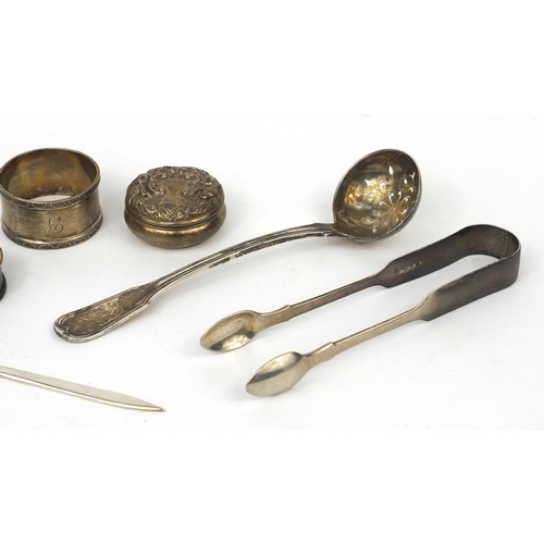 2473 - Silver items comprising Scottish sifting spoon, Victorian sugar tongs, three napkin rings, pair of s... 