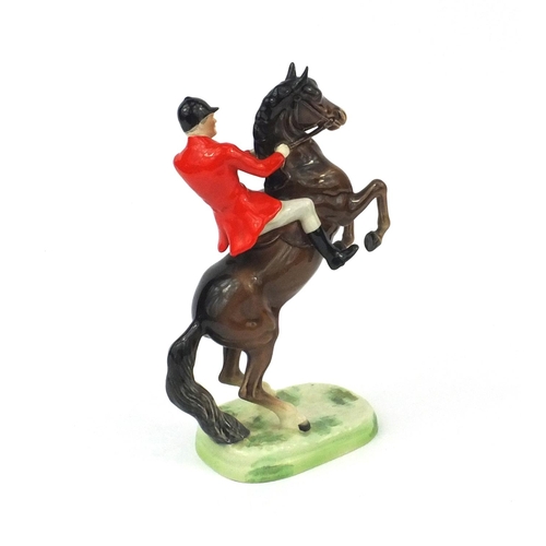 2112 - Beswick huntsman on a rearing horse, factory marks and numbered 868 to the base, 25cm high