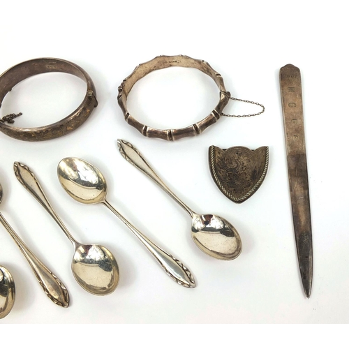 2418 - Silver items including three bangles, vesta, letter opener and teaspoons, approximate weight 187.0g