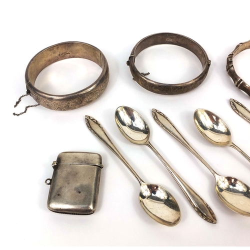 2418 - Silver items including three bangles, vesta, letter opener and teaspoons, approximate weight 187.0g