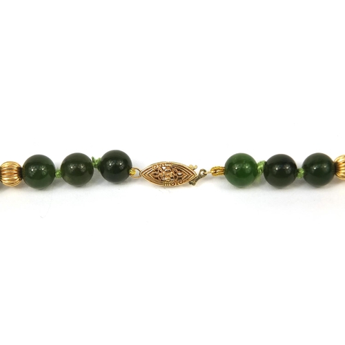 2550 - Green jadeite and 14ct gold necklace, 66cm long, approximate weight  51.2g