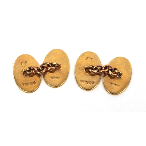 2561 - Pair of oval 9ct gold cufflinks with engine turned decoration, 1.8cm long, approximate weight  7.4g