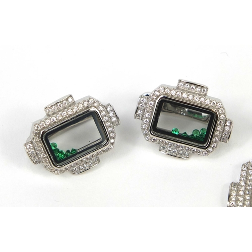 2596 - Silver cubic zirconia jewellery suite, each set with floating green glass stones, the ring size N, a... 