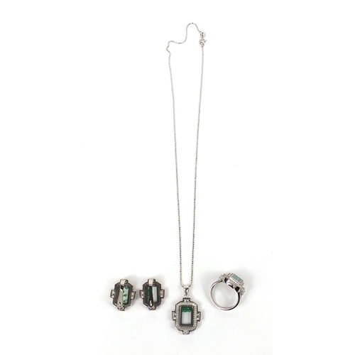 2596 - Silver cubic zirconia jewellery suite, each set with floating green glass stones, the ring size N, a... 