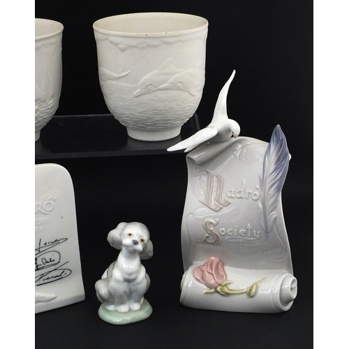 2134 - Group of Lladro including Lladro Society scroll and a pair of cups decorated with dolphins, the larg... 