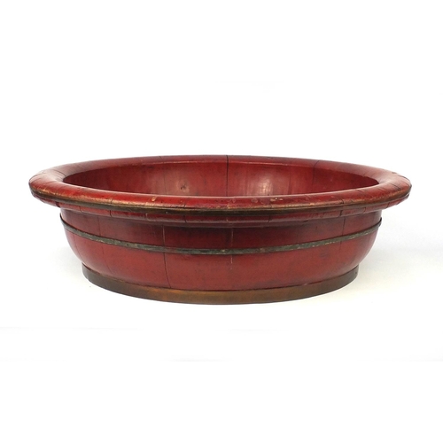 2068 - Large red lacquered metal bound bowl, 70cm diameter