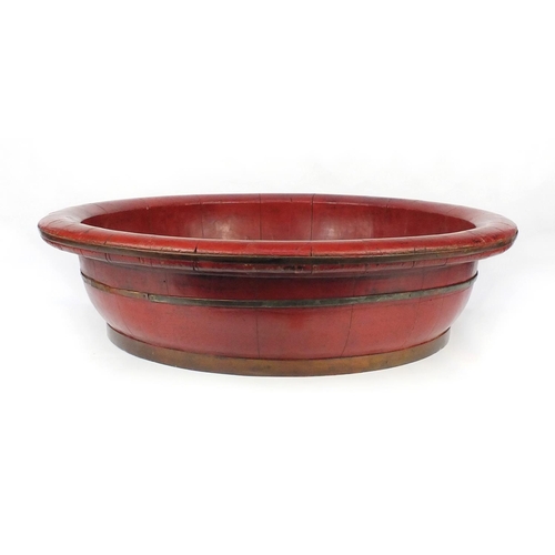 2068 - Large red lacquered metal bound bowl, 70cm diameter