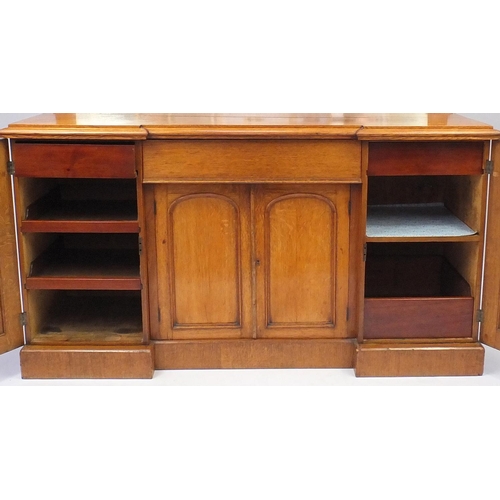 2010 - Victorian oak inverted breakfront sideboard with mirrored back, centre drawer aand four paneled cupb... 