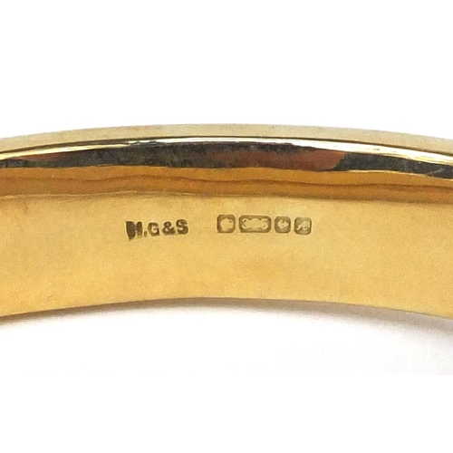 2501 - 9ct gold bangle with floral chased decoration, 6.5cm long x 1.3cm wide, approximate weight 17.8g