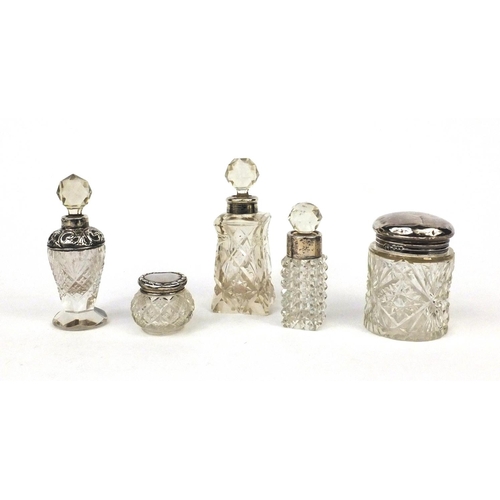 2455 - Five cut glass bottles and jars with silver lids and collars, various hallmarks, the largest 11.5cm ... 