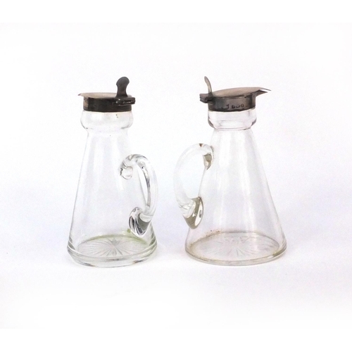 2414 - Pair of silver topped glass whisky tots, both with indistinct London hallmarks, each 11.5cm high