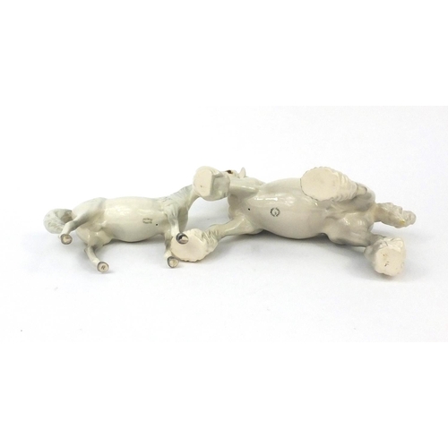 2109 - Two Beswick dappled grey horses including a Shire horse, each with factory marks to the bases, the l... 