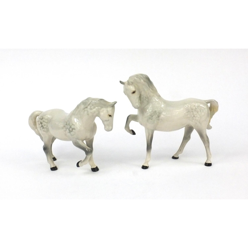 2110 - Two Beswick dappled grey horses trotting, factory marks to the base, the largest 19cm high