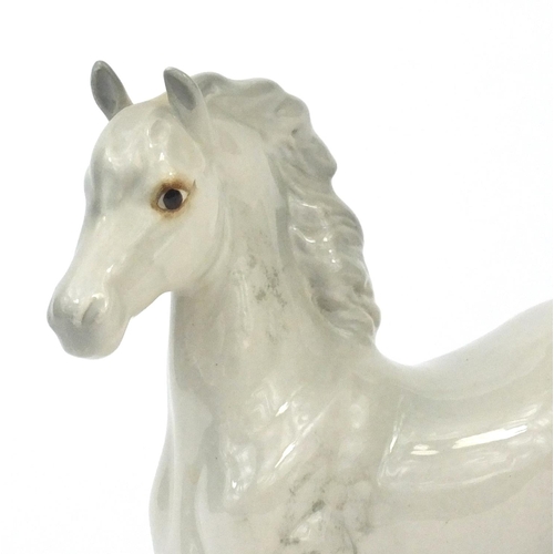 2107 - Beswick dappled grey horse with raised hoof, factory marks to the base, 16.5cm high