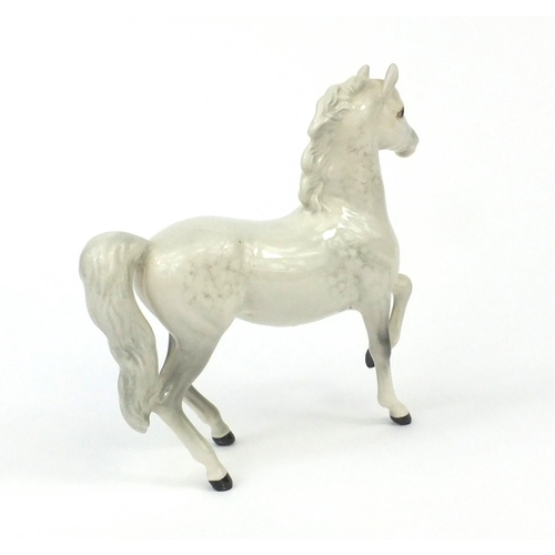 2107 - Beswick dappled grey horse with raised hoof, factory marks to the base, 16.5cm high