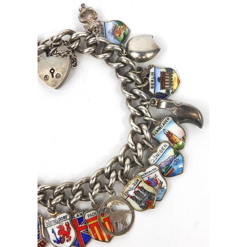 2615 - Silver charm bracelet with a large selection of enamelled shield souvenir charms, approximate weight... 