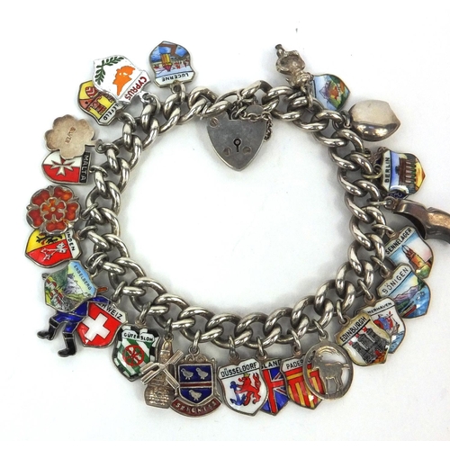 2615 - Silver charm bracelet with a large selection of enamelled shield souvenir charms, approximate weight... 