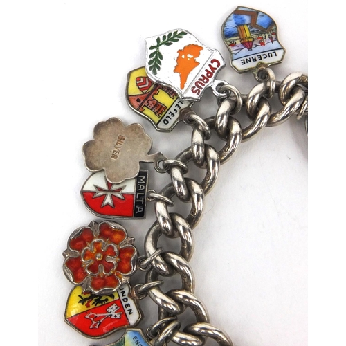 2615 - Silver charm bracelet with a large selection of enamelled shield souvenir charms, approximate weight... 