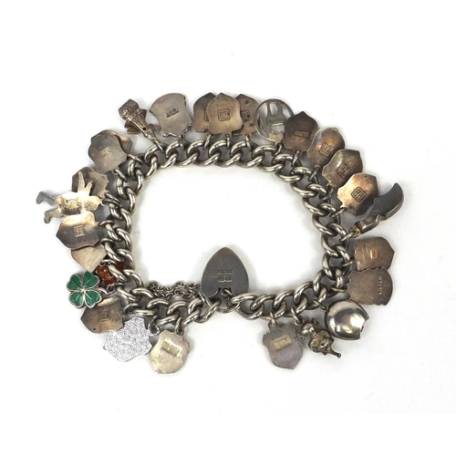 2615 - Silver charm bracelet with a large selection of enamelled shield souvenir charms, approximate weight... 