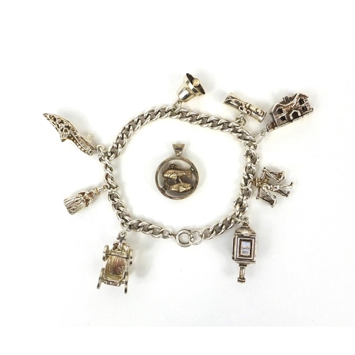 2621 - Silver charm bracelet with selection of mostly silver charms including railway lantern, Dutch figure... 