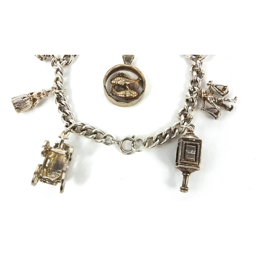 2621 - Silver charm bracelet with selection of mostly silver charms including railway lantern, Dutch figure... 