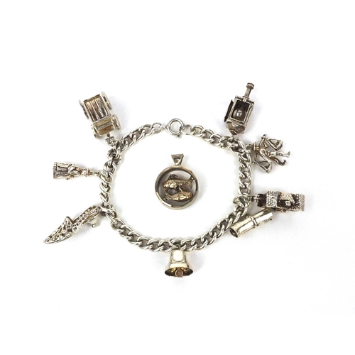 2621 - Silver charm bracelet with selection of mostly silver charms including railway lantern, Dutch figure... 