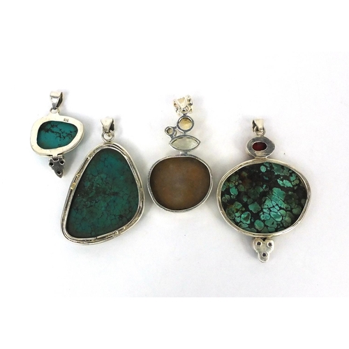 2543 - Four large silver pendants set with semi precious stones including turquoise, quartz and amethyst, t... 